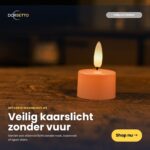 Pojedynczy różowy tealight LED z możliwością ładowania świeci ciepłym światłem na drewnianej powierzchni. Ciesz się bezpiecznym światłem świec - kup zestaw 12 bezpłomieniowych podgrzewaczy Dorsetto (czas palenia do 400 godzin, z pilotem) już dziś!.